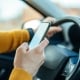 Shot of a male using mobile phone while driving the car.