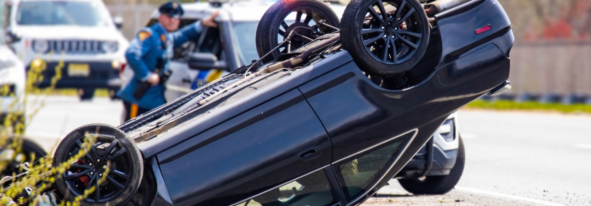 Vehicle rollover highway road accident with police in the back