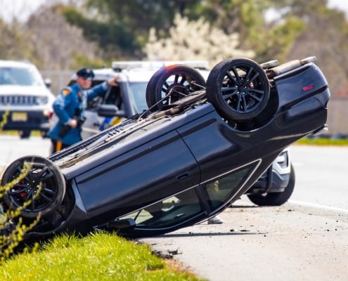 Vehicle rollover highway road accident with police in the back