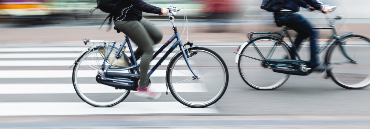 picture with camera made motion blur effect of bicycle riders on a city street