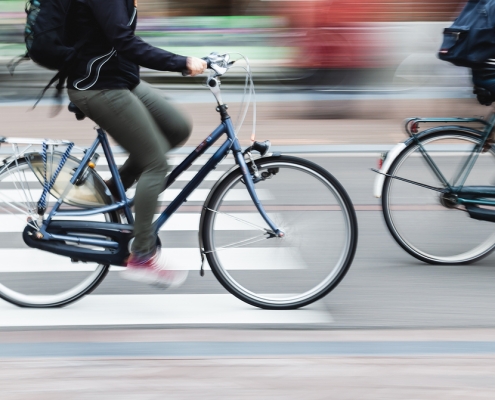 picture with camera made motion blur effect of bicycle riders on a city street