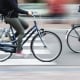 picture with camera made motion blur effect of bicycle riders on a city street