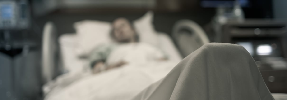 Sick woman lying in the hospital bed.