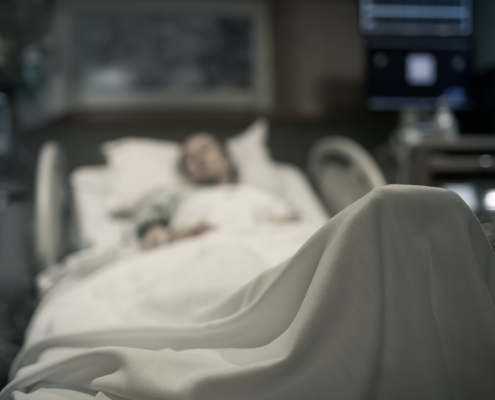 Sick woman lying in the hospital bed.