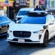 Waymo Jaguar driverless car drives on urban street in San Francisco