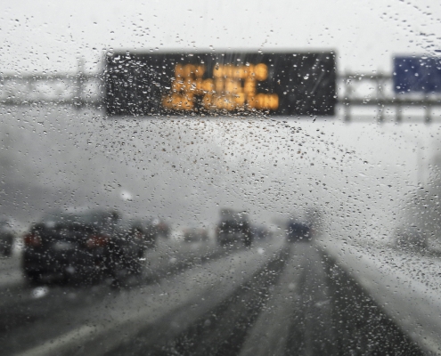 hazardous weather condition on the road seen through windshield