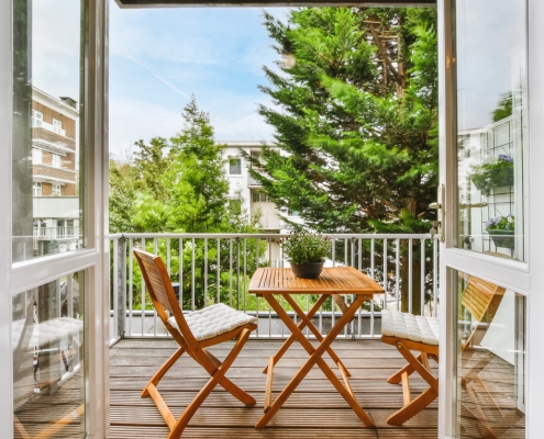 A beautiful image of a tiny outdoor balcony with a green view; design ideas