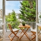 A beautiful image of a tiny outdoor balcony with a green view; design ideas