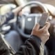 Using a phone in a car texting while driving concept for danger of text message and being distracted