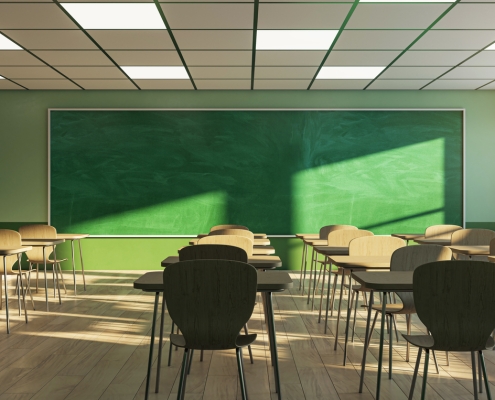 An empty classroom with chairs, desks, and a green chalkboard, illuminated by sunlight, evoking education concept. 3D Rendering