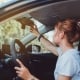 Safety driving woman adjust the car rearview mirror in interior before start travel trip every time.