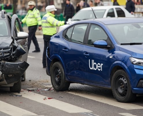 Bucharest, Romania - March 02, 2023: An Uber logo branded car on the road at the place where it was involved in a car accident. This image is for editorial use only.