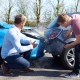 Two Drivers Arguing After Traffic Accident looking at damage