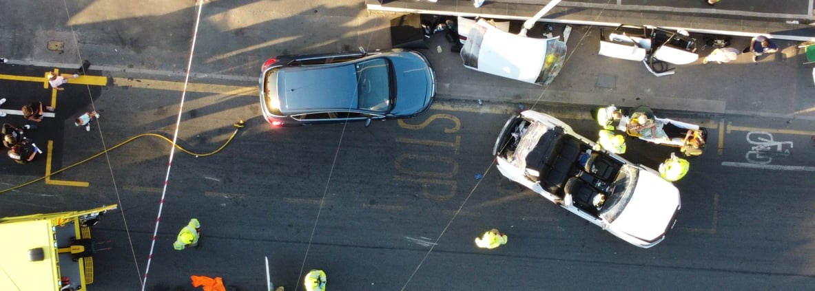 Car accident between two cars seen in aerial view.