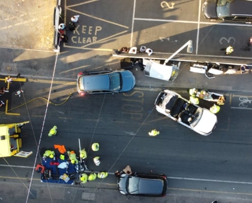 Car accident between two cars seen in aerial view.