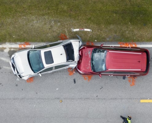 Car crash with two vehicles collided at traffic accident site on American street.