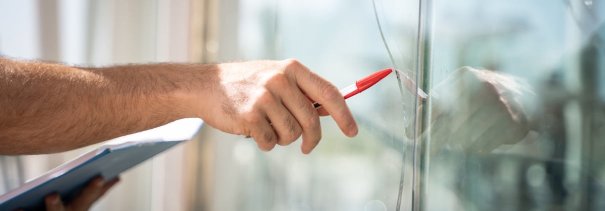 glass broken from a house by an accident, man checking to repair